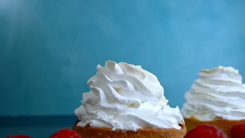 Children hand puts raspberry on a cake of meringue cake Stock Footage 124450795