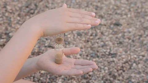 Children hand sand clock stone background hd footage Stock Footage 109209264