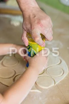 Children hands cook the circles of dough Stock Photos