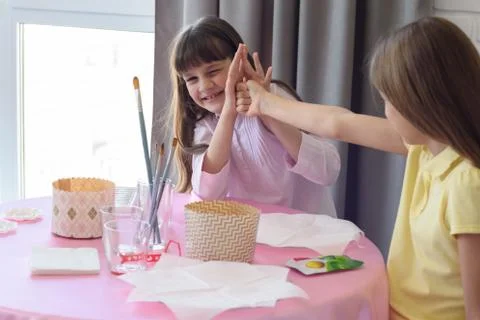 Children have fun fighting while sitting at a table in the kitchen Stock-Fotos