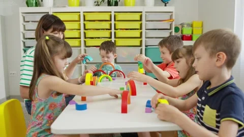 Children have fun making figures from the elements of the rainbow. Stock Footage 247457460