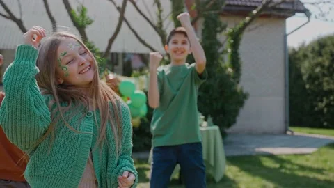 Children having fun dancing at a backyard birthday party on a sunny day Video stock 197882462
