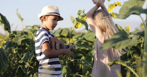 Children having fun in the field with sunflowers in the summer. Stock Footage 101570570