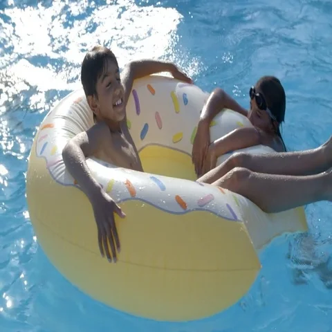 Children Having Fun With Inflatable In Outdoor Swimming Pool Stock Footage 69410535