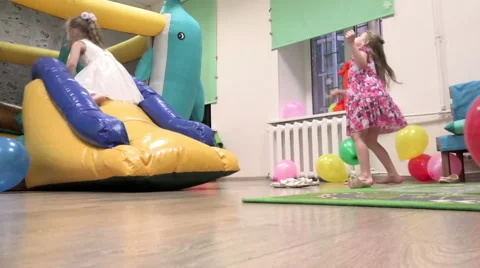 Children having fun at a party jumping on a trampoline with balloons Stock Footage 47209088