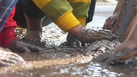 Children having fun playing in the mud Stock Footage 310116463
