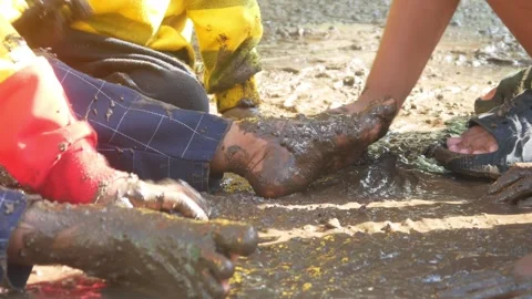 Children having fun playing in the mud Stock Footage 310116715