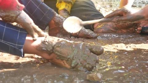 Children having fun playing in the mud Stock Footage 310116720