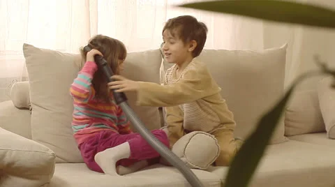 Children having fun playing with vacuum cleaner. Stock Footage 22919425