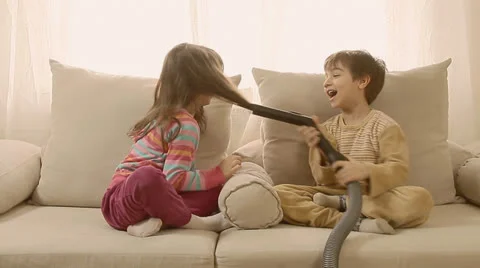 Children having fun playing with vacuum cleaner. Stock Footage 22923521