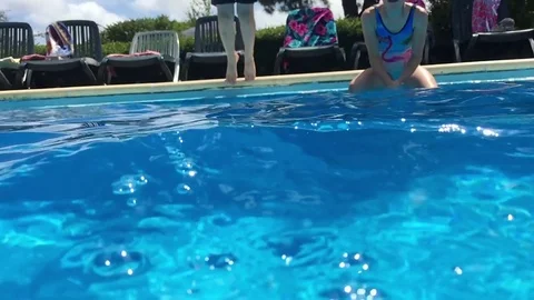 Children having fun in the pool on a hot summers day. Amazing slow motion Stock Footage 79592928