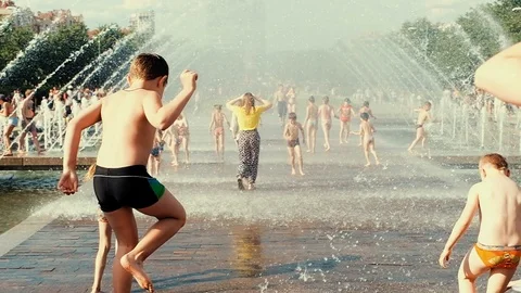 Children having fun running between water flow Stock Footage 91607932