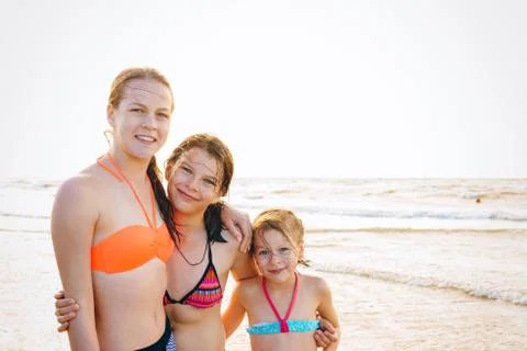 Children having fun at sunset beach - friendship freedom summer holiday conce 写真素材