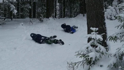Children having fun in the winter forest, 4k footage Stock Footage 70454903