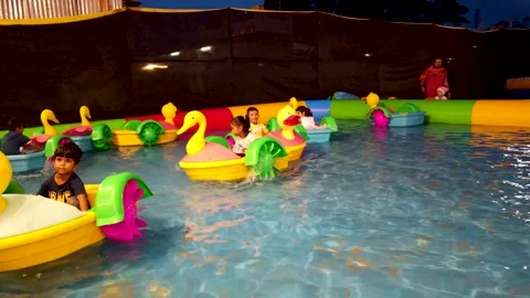 Children having a happy time with their small boats Amusement Park in India. Stock Footage 282362383