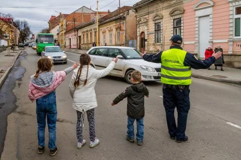 Children help a policeman Stock Photos