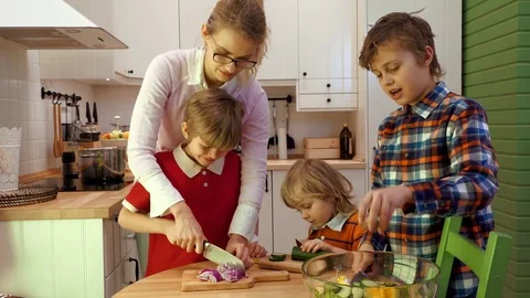 Children helping Mom in kitchen Stock Footage 73315741