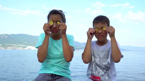 Children hold potato chips in front of their eyes 4K Stock Footage 158032208