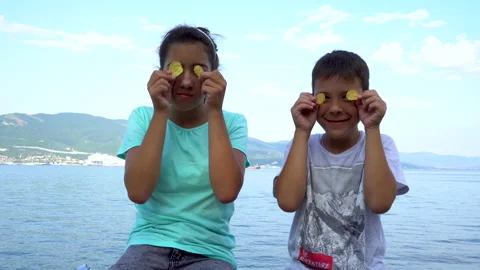 Children hold potato chips in front of their eyes and laugh 4K Stock Footage 158032223
