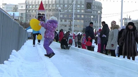 CHILDREN IN ICE TOWN MOVE DOWN FROM ICE SLIDE. CHELYABINSK, RUSSIA Stock Footage 59836816