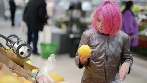 Children independence to make purchases to help parents. A girl with pink hair Stock-Footage 169258062