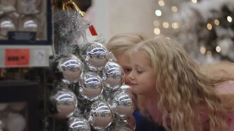 Children indulge in the store and make faces and laugh looking at Christmas Stock Footage 166266183