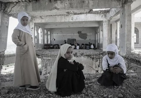 Children inside a destroyed school due to the war in Yemen, Taiz Stock Photos