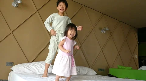Children Jump on the Bed in Slow Motion. Stock Footage 61295454