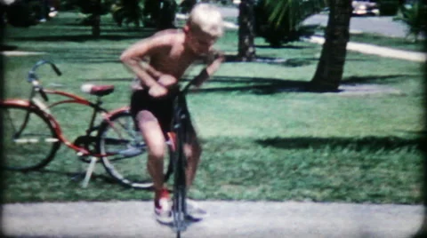 Children jump on pogo sticks in suburbia 1950s vintage film home movie 1242 Stock Footage