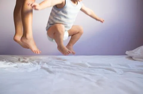 Children jumping on bed Stock Photos