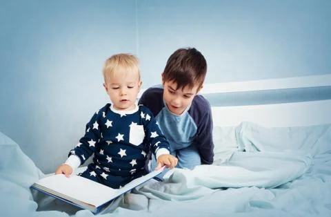 Children jumping on the bed Stock Photos