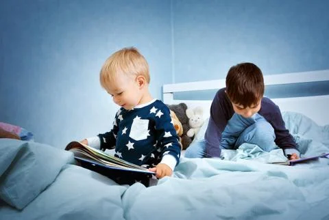 Children jumping on the bed Stock Photos