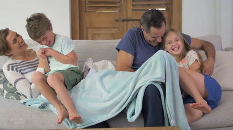 Children jumping onto couch Video stock 57827885