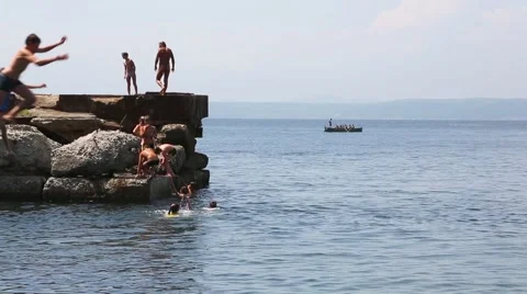Children jumping diving into the sea from the old pier, Vladivostok. Russia Stock Footage 53255111