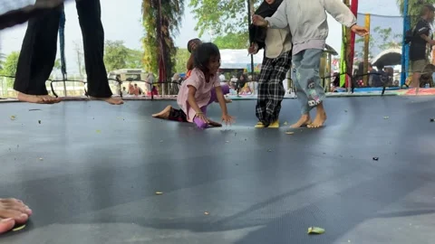 Children Jumping on a Trampoline Stock Footage 326632334
