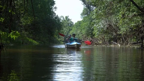 Children in a kayak float on the river Stock Footage 99352708