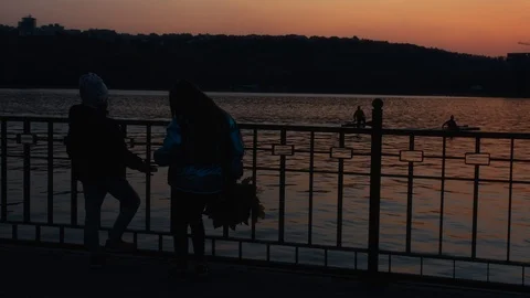 Children at the lake on a sunset. Stock Footage 97182274