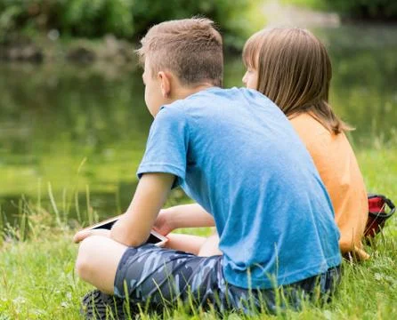 Children at lakeside Stock Photos