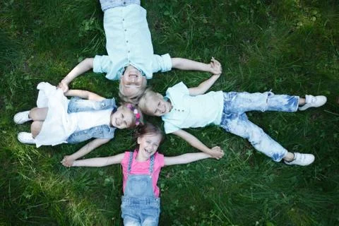 Children laying grass Stock Photos