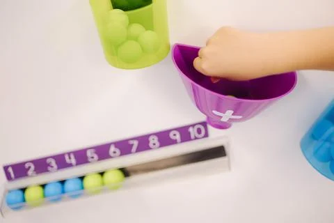 Children learn to count using colorful balls. Kindergarden. Education for kids Stock Photos