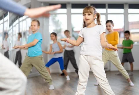 Children learn to dance modern dances, repeat movement for unrecognizable Stock Photos