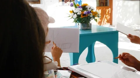 Children learn to draw. the teacher talks about the subtleties of drawing Stock Footage 124841504