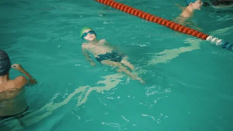  Children learn to swim in pool.  Stock Footage 213662553