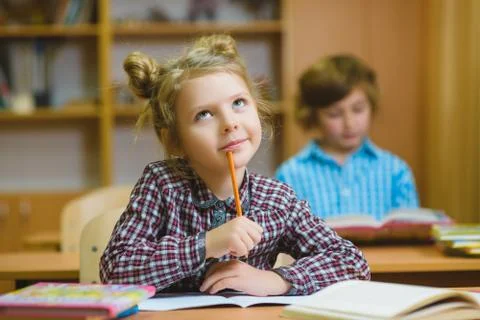 Children learning and doing homework in school classroom Stock Photos