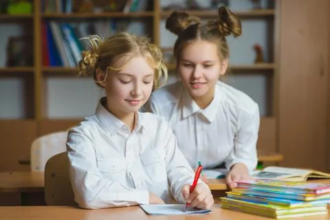 Children learning and doing homework in school classroom Stock Photos