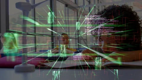 Children learning in classroom as boy reaching desk and activating green grid Stock Footage 313678458