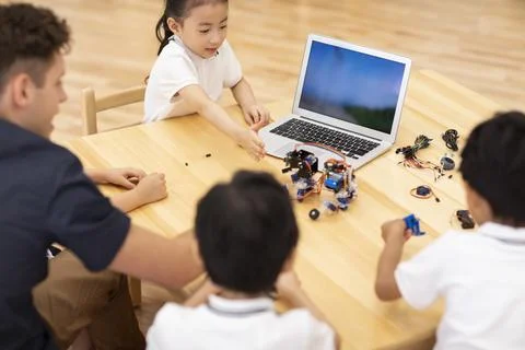 Children learning coding in classroom Stock Photos