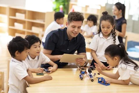 Children learning coding in classroom Stock Photos