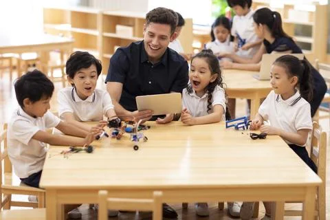 Children learning coding in classroom Stock Photos