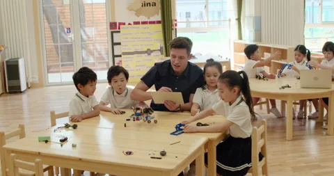 Children learning coding in kindergarten classroom,4K Stock Footage 146869647